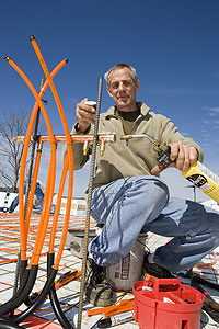 Bob &ldquo;Hot Rod&rdquo; Rohr installs radiant heat equipment on an under-concrete job in Branson, Mo.